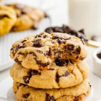 Stacked chocolate chip cookies on a plate.