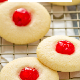 Cherry Shortbread cookies on a cooling rack with a napkin underneath.
