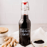 Elderberry syrup in a glass bottle.