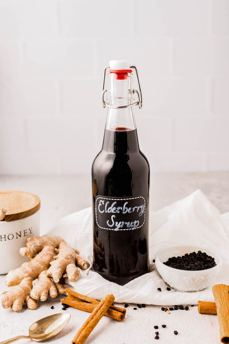 Elderberry syrup in a glass bottle.