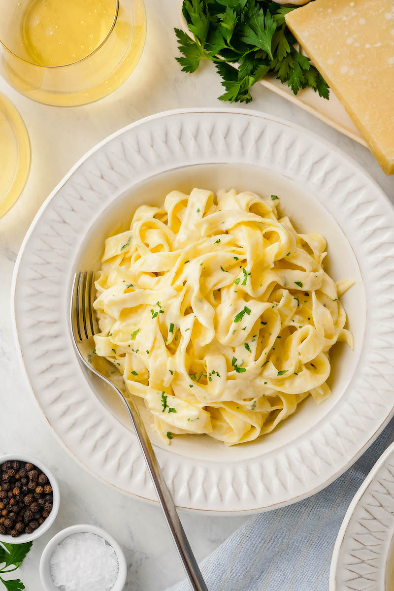 Bowl of fettuccine alfredo with a fork.