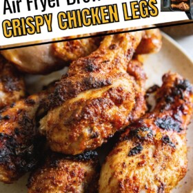 A plate is topped with a small pile of air fryer chicken legs.