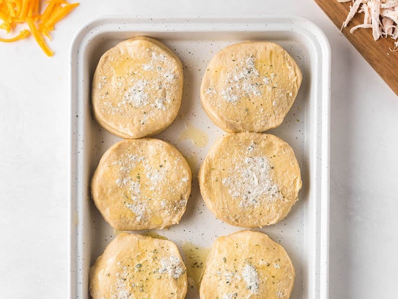 Uncooked biscuits on a baking sheet with ranch seasoning