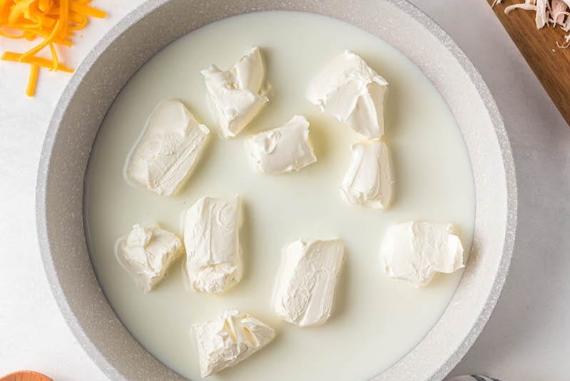 Top view of cream cheese and milk mixture in a saucepan
