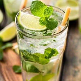 Rum mixed with simple syrup, fresh mint leaves, and lime wedges.