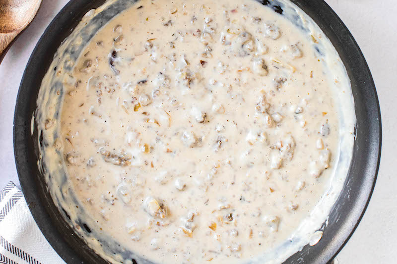 Overhead image of sausage gravy in a non stick skillet.