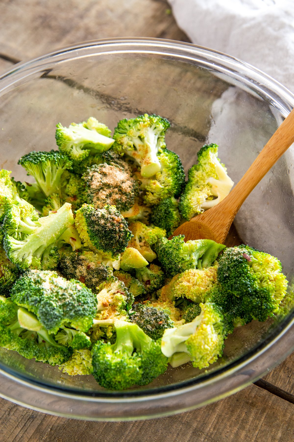 Seasoned broccoli florets in a bowl.