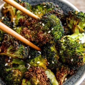 Roasted broccoli in chopsticks.