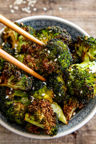 Roasted broccoli in chopsticks.