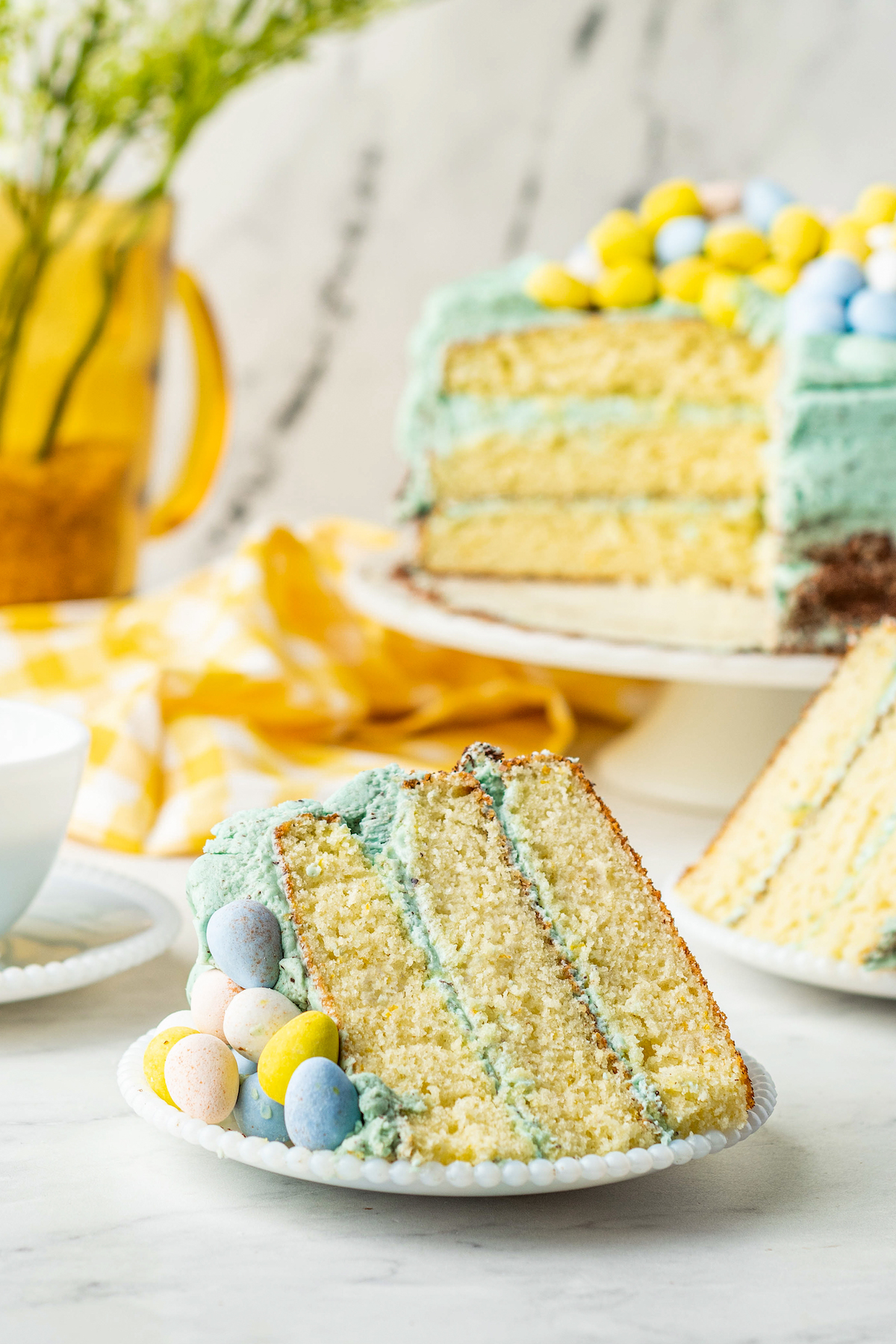 Slice of triple layer Easter cake on a plate.