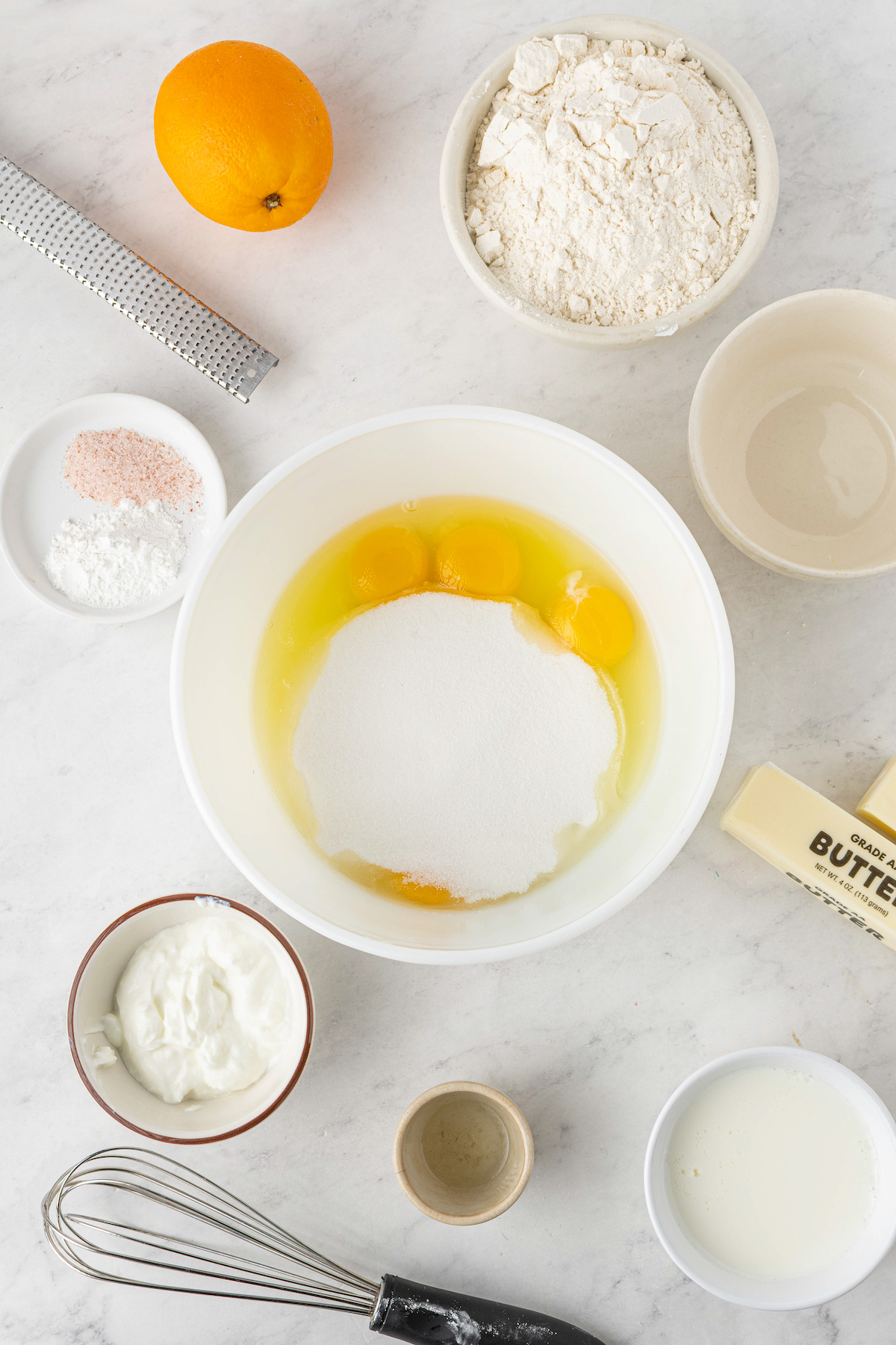 Eggs and sugar in a mixing bowl.