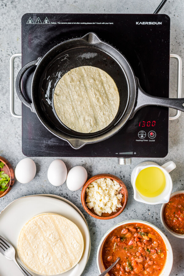 Corn tortilla in a frying pan.