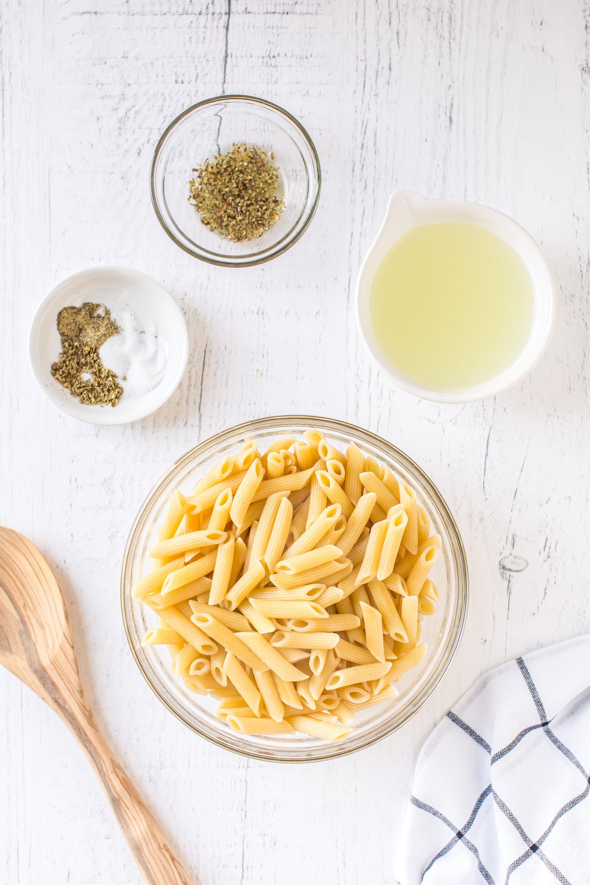 Bowl of pasta with herbs and olive oil.
