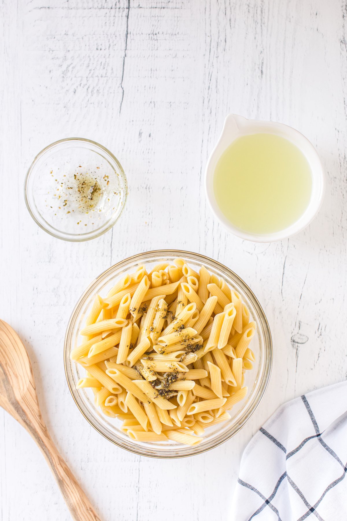 Penne pasta with herbs in a bowl.