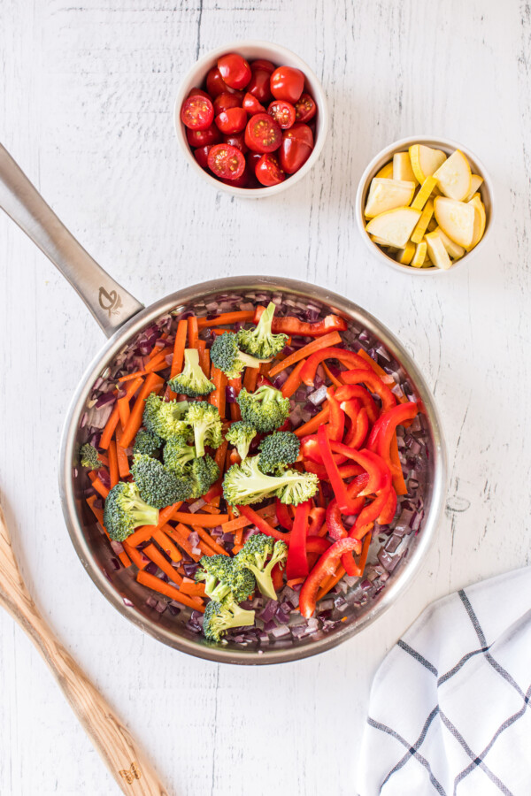 Broccoli, carrots, and peppers in a pan.