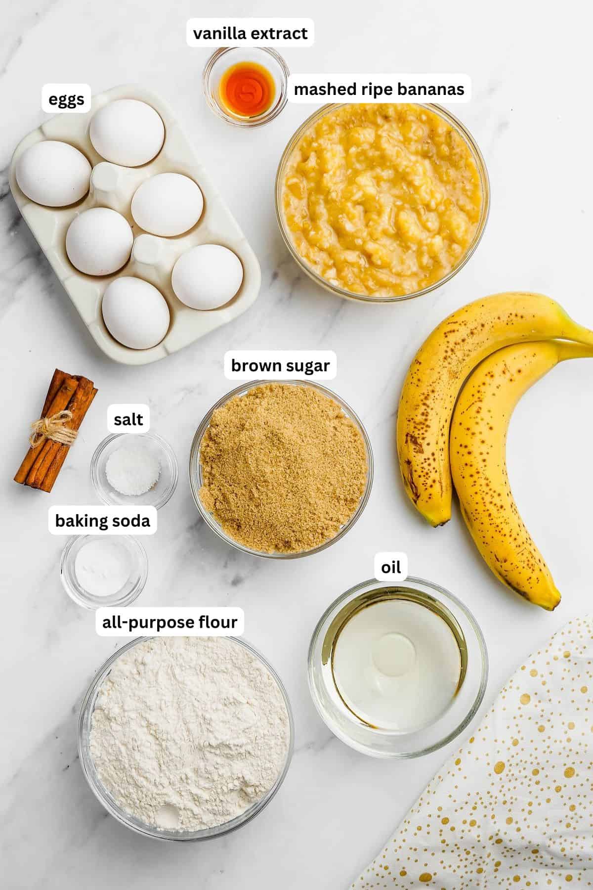 Banana bread recipe with brown sugar ingredients in order from top to bottom: eggs, vanilla, mashed bananas, salt, brown sugar, baking soda, oil, all purpose flour.