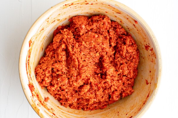 Ground pork with chili sauce marinating in a bowl