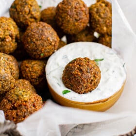 Plate of falafel with a bowl of dip.