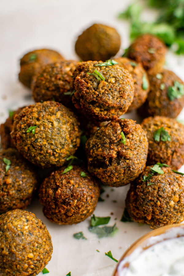 Pile of falafel with chopped parsley.