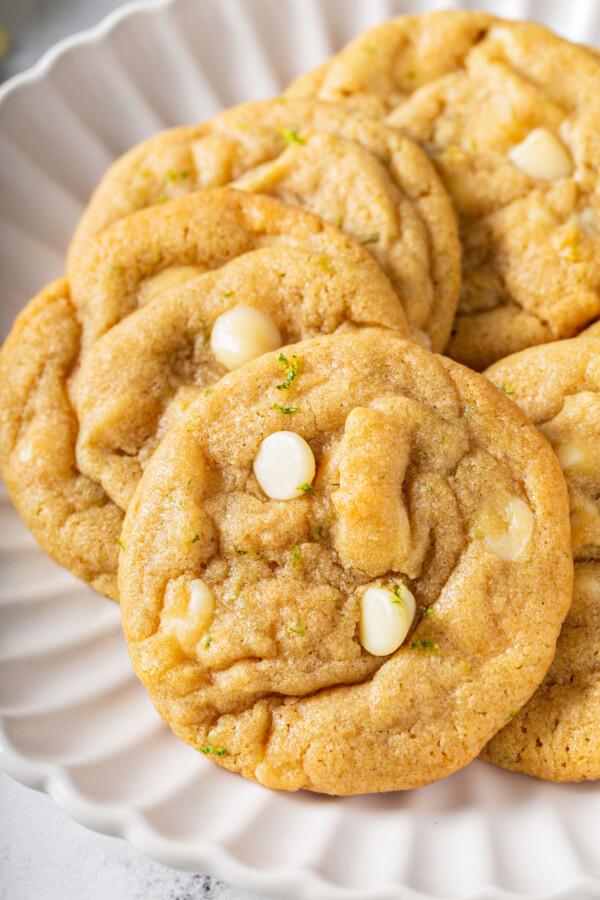 A close up shot shows white chocolate chips baked into zested cookie dough.