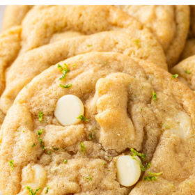 A close up shot shows white chocolate chips baked into zested cookie dough.