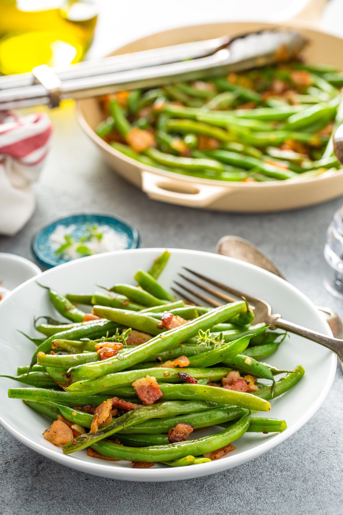 Plate of green beans with bacon bits.