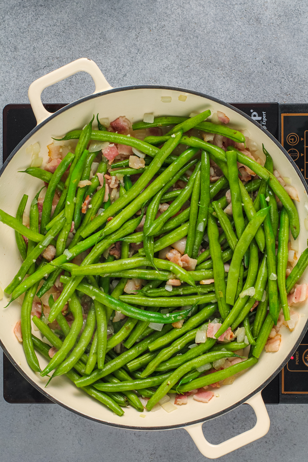 Fresh green beans cooking in a pan.