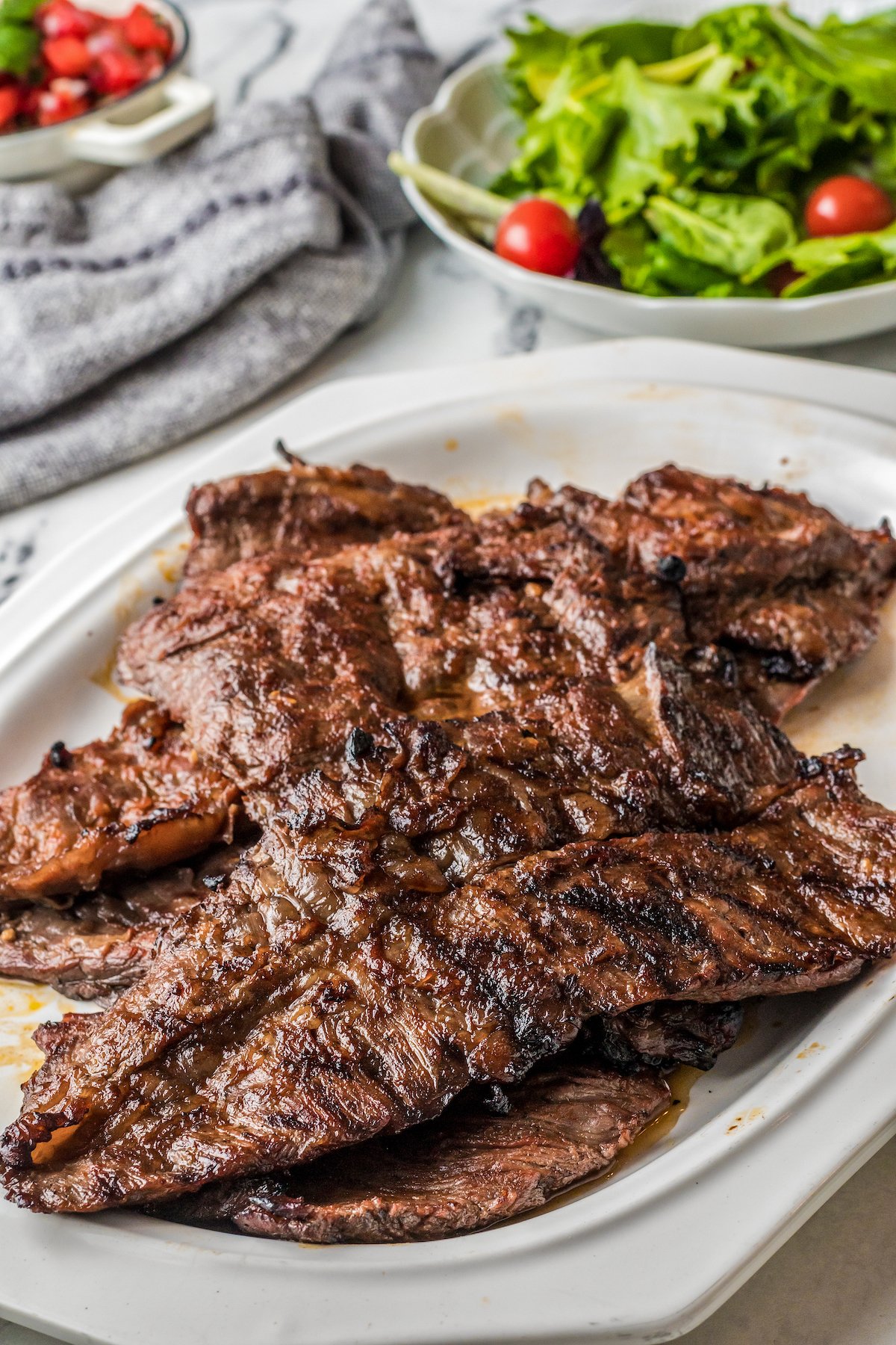 A plate of tender, grilled flank steaks.
