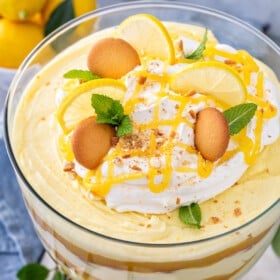 Overhead image of a lemon pudding trifle with cookies and lemon curd on top.