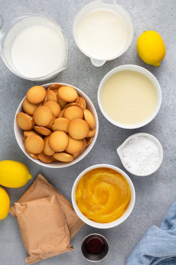 Ingredients for lemon pudding in white bowls. 