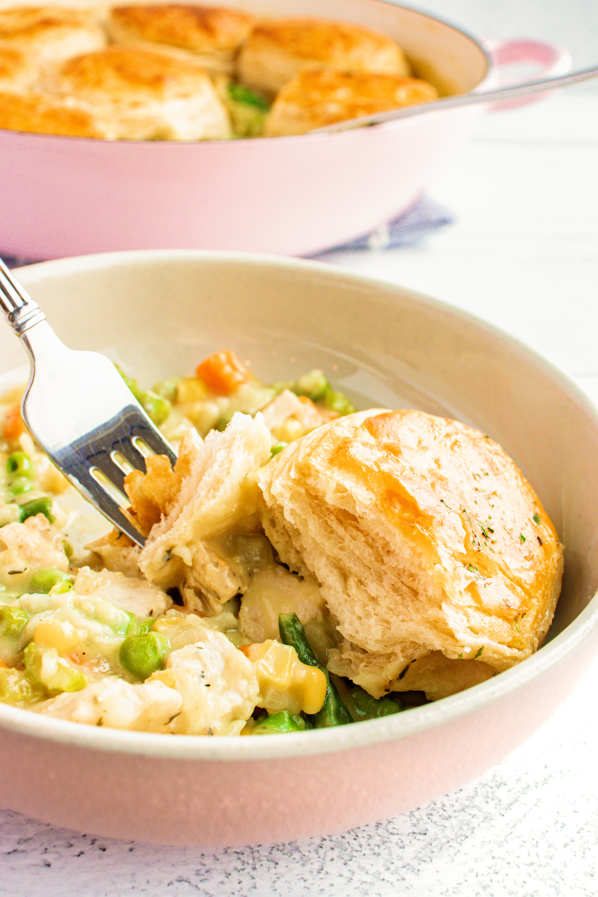 Bowl of skillet chicken pot pie with biscuits.