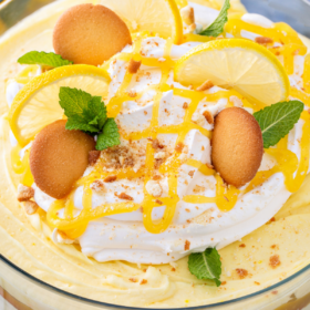 Overhead image of a lemon pudding trifle with cookies and lemon curd on top.