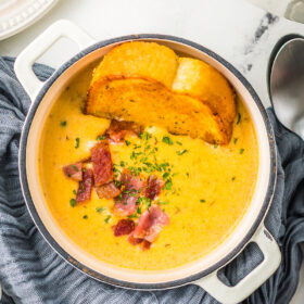 Beer cheese soup with crispy bacon and bread.