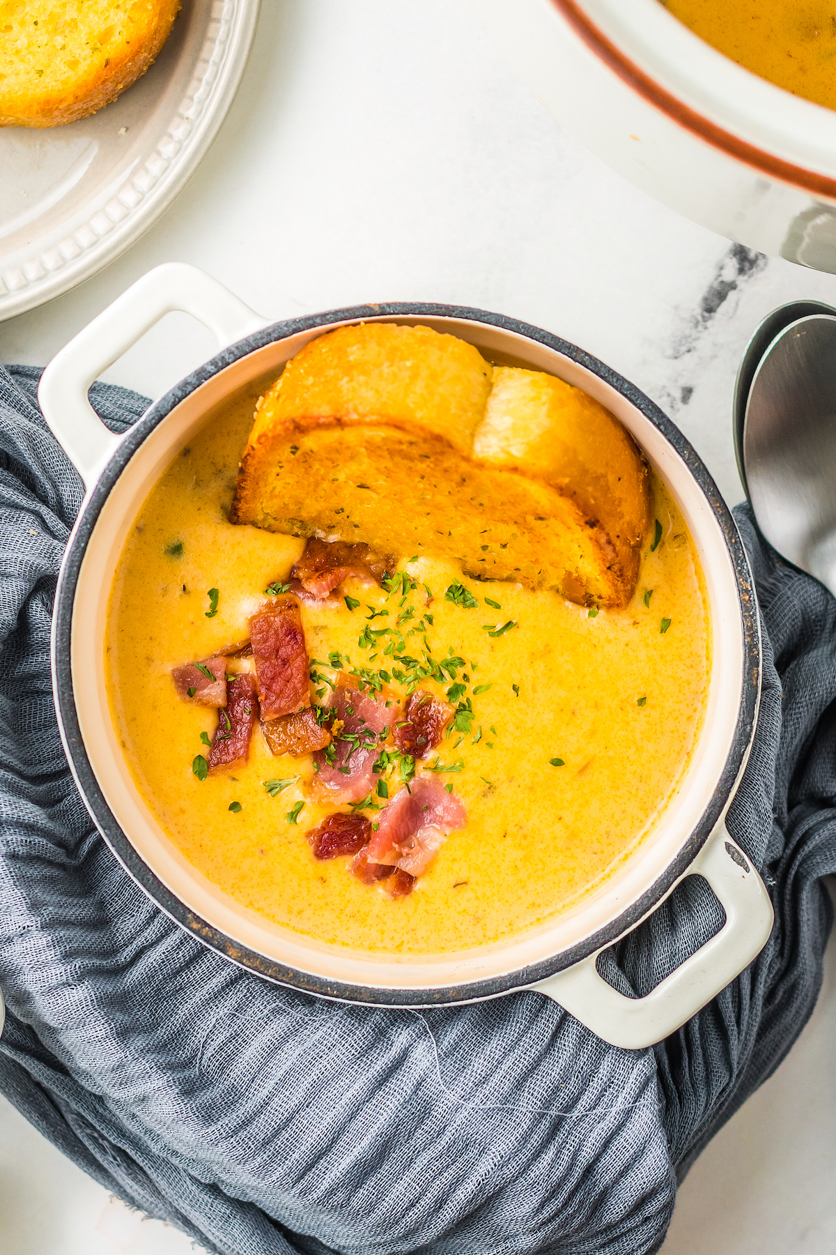 Beer cheese soup with crispy bacon and bread.