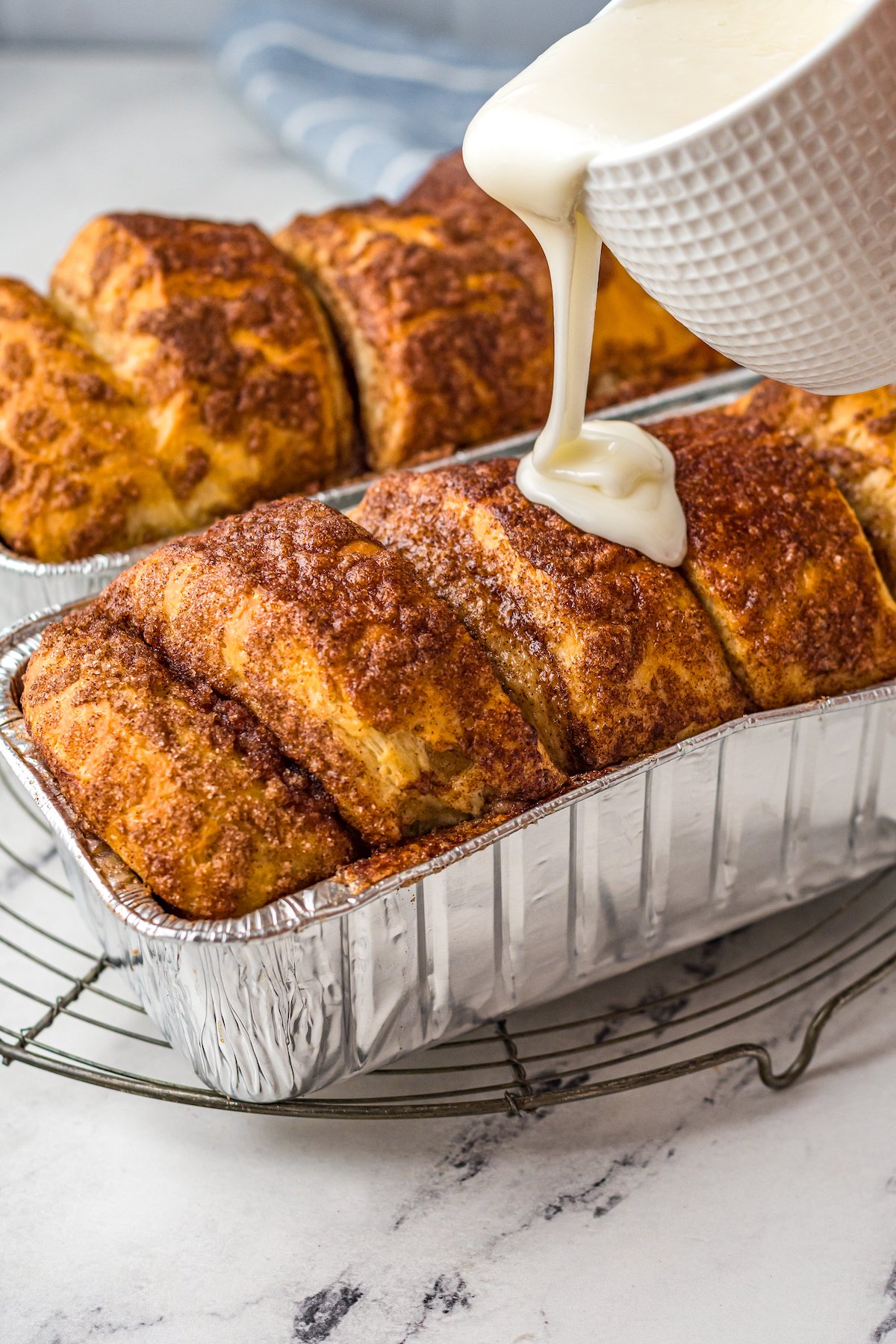 Pull apart bread loaves with vanilla icing poured on top.