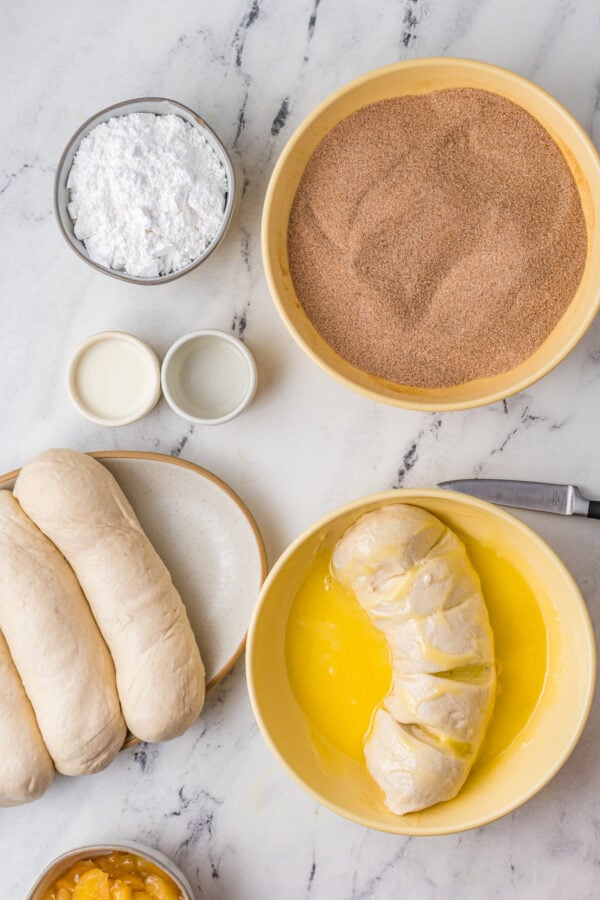 Sliced loaf of frozen bread, coated in butter.