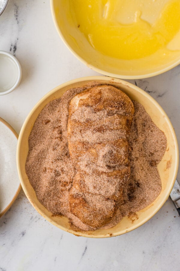 Bread dough covered in cinnamon sugar.
