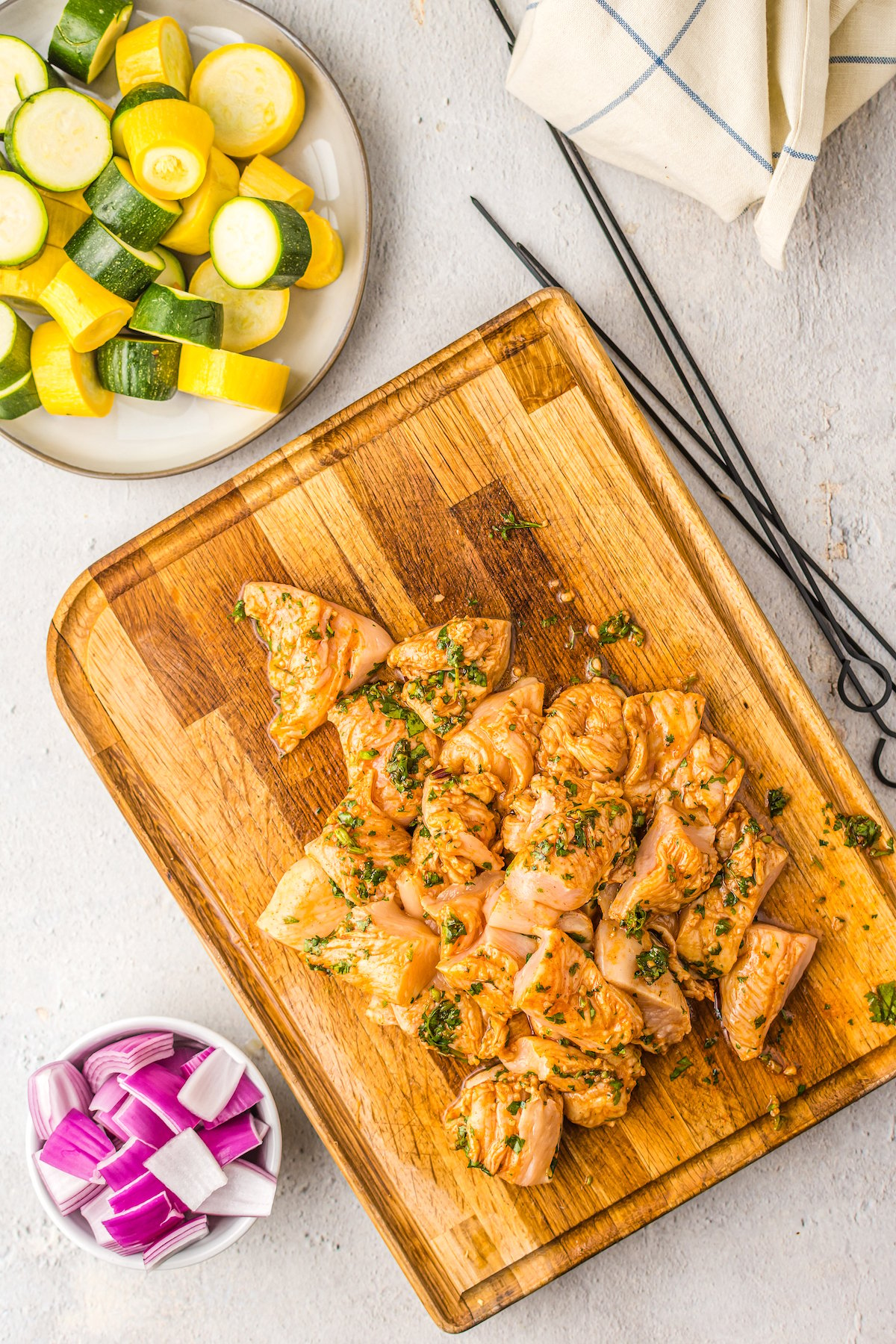 Marinated chicken on a cutting board.