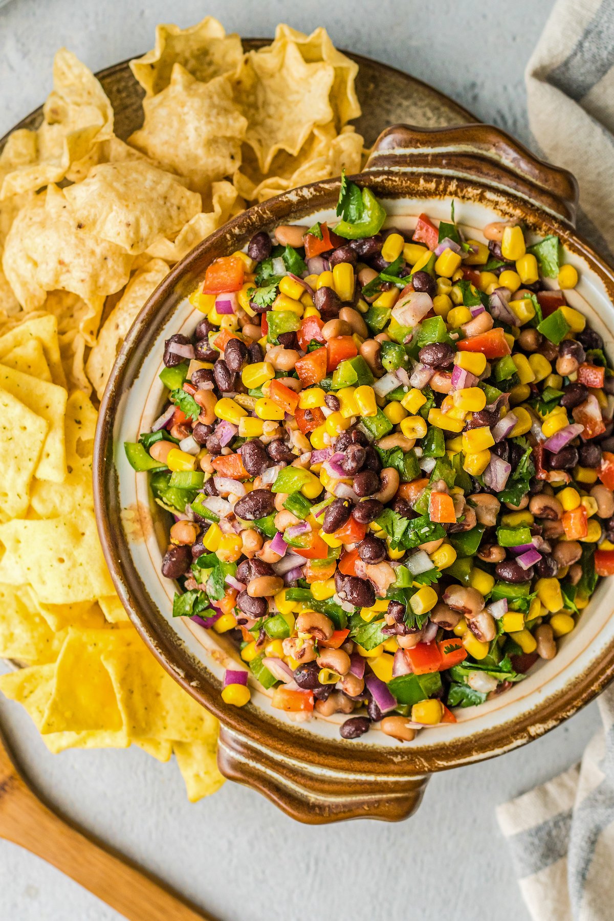 Corn, beans, and peppers, covered in dressing.