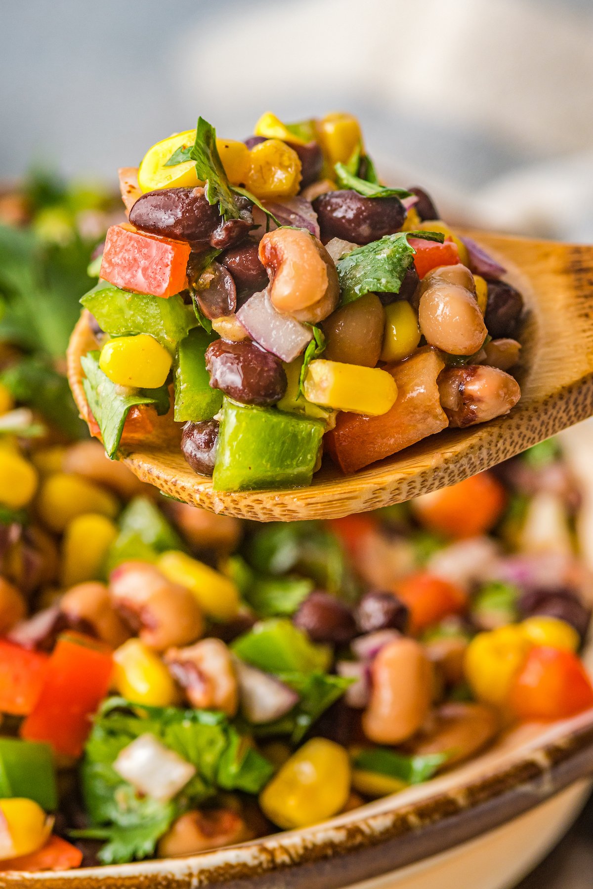 Peppers, corn, and beans, coated in vinaigrette.