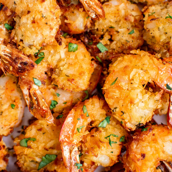 Slightly sweet and juicy air fryer coconut shrimp with a golden brown coconut coating topped with fresh parsley.