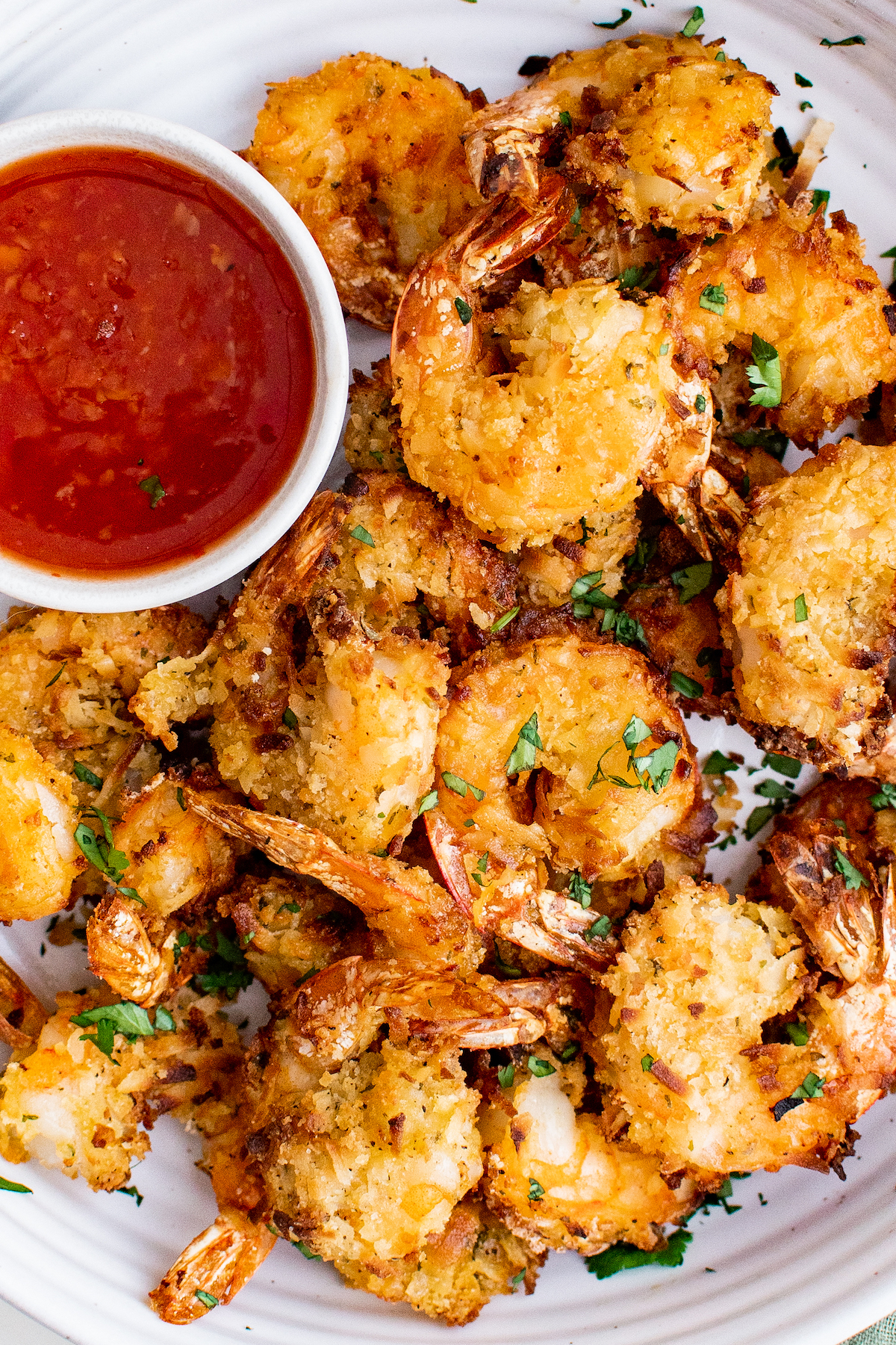 Coconut air fryer shrimp with sweet chili dipping sauce on the side.