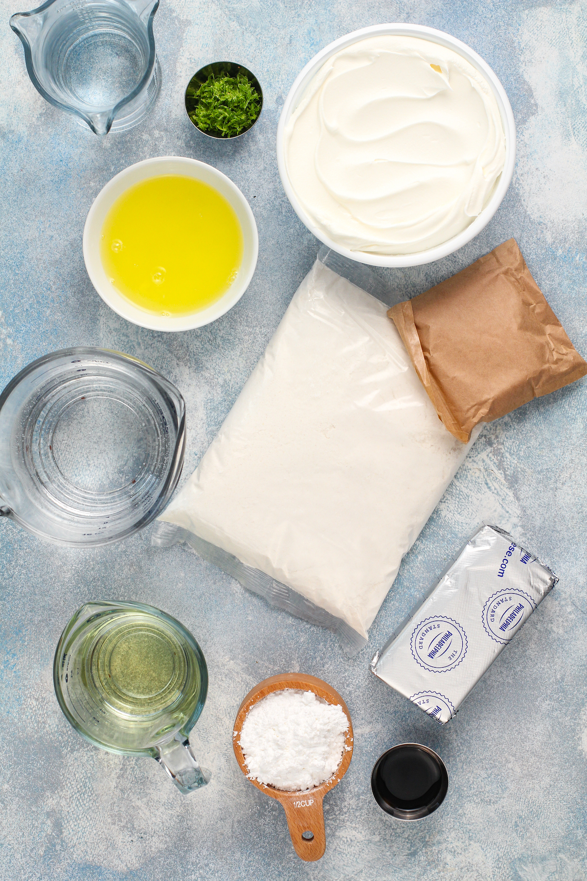 Ingredients for cake in bowls on a blue background.