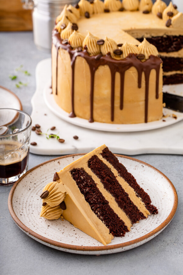 A slice of cake is on a small white plate. 