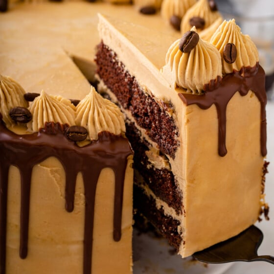 A slice of cake is being removed from the cake itself.