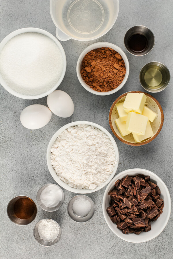 The ingredients for chocolate espresso cake are placed on a gray surface. 