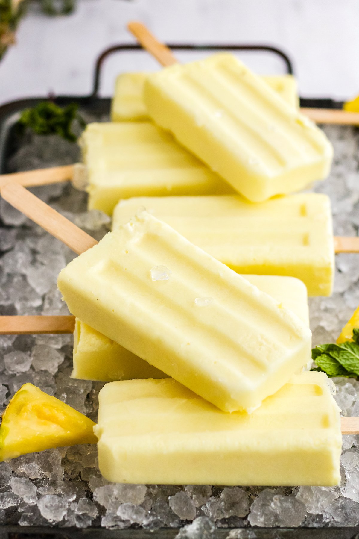 stack of dole whip popsicles on a metal tray