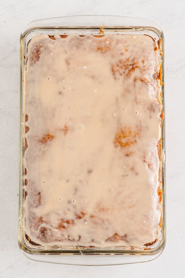 Vanilla glaze on top of honeybun pumpkin cake.