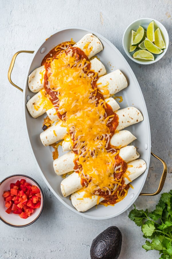 Baked chicken enchiladas with shredded cheese.