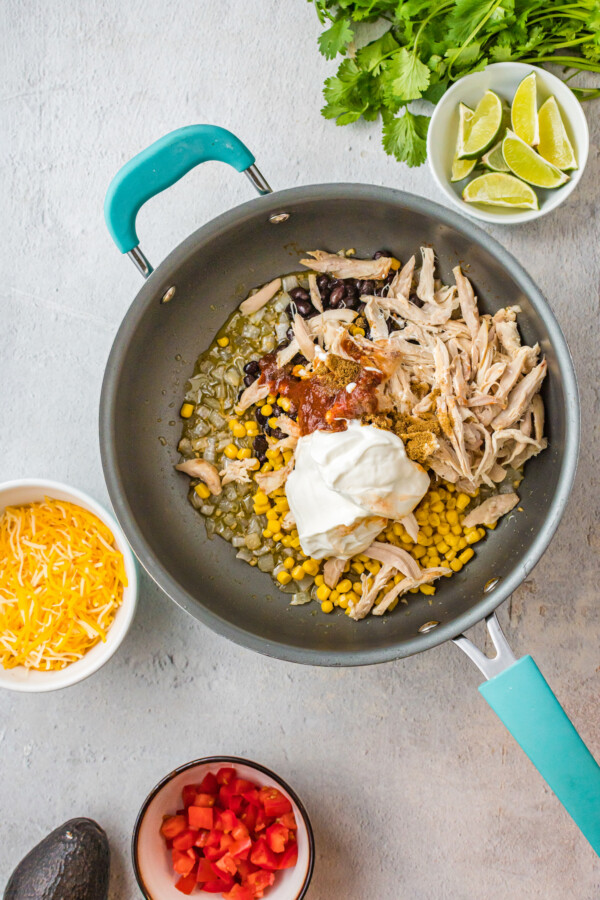 Shredded chicken, corn, and black beans in a pan.